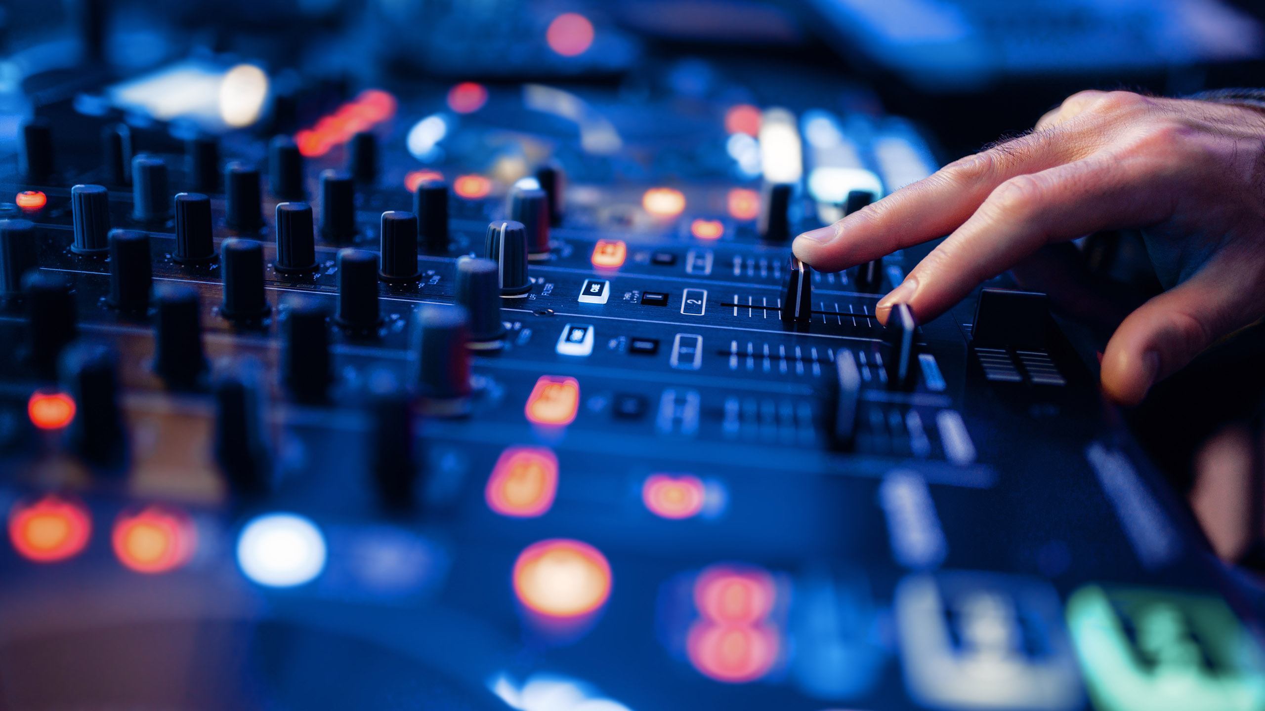 Sound operator hands at the volume control panel in the recording studio. Musician at the mixer, professional audio mixing